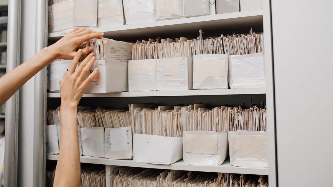 woman reaching for paperwork