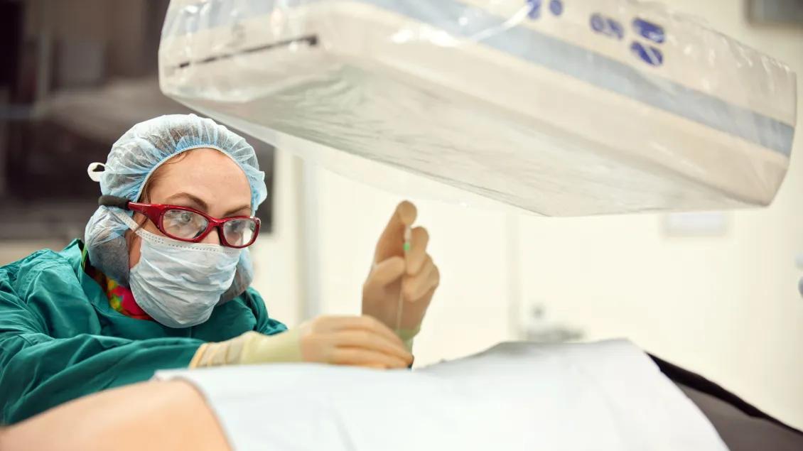 Doctor examines patient under MRI scanner