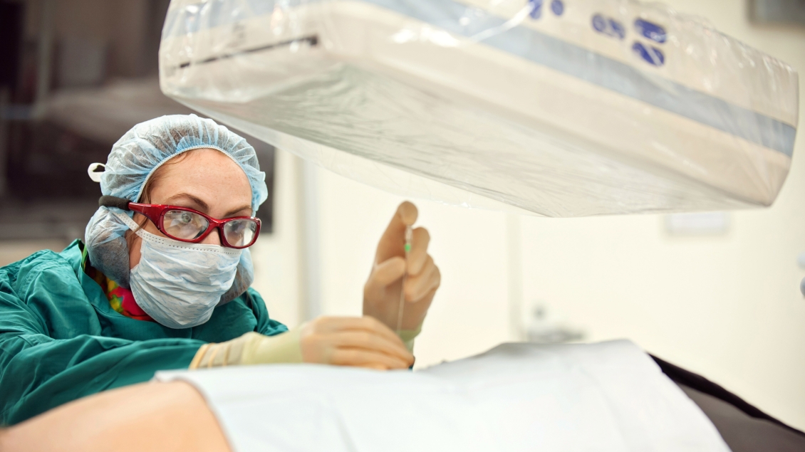 Doctor examines patient under MRI scanner