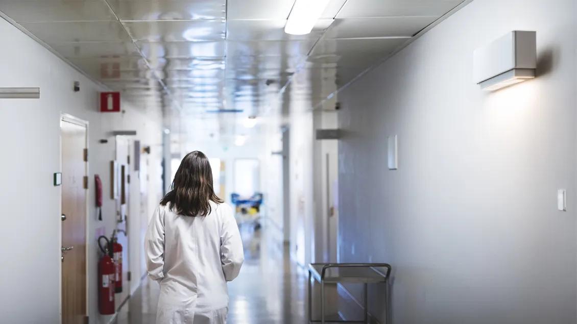doctor walking down a hospital hallway