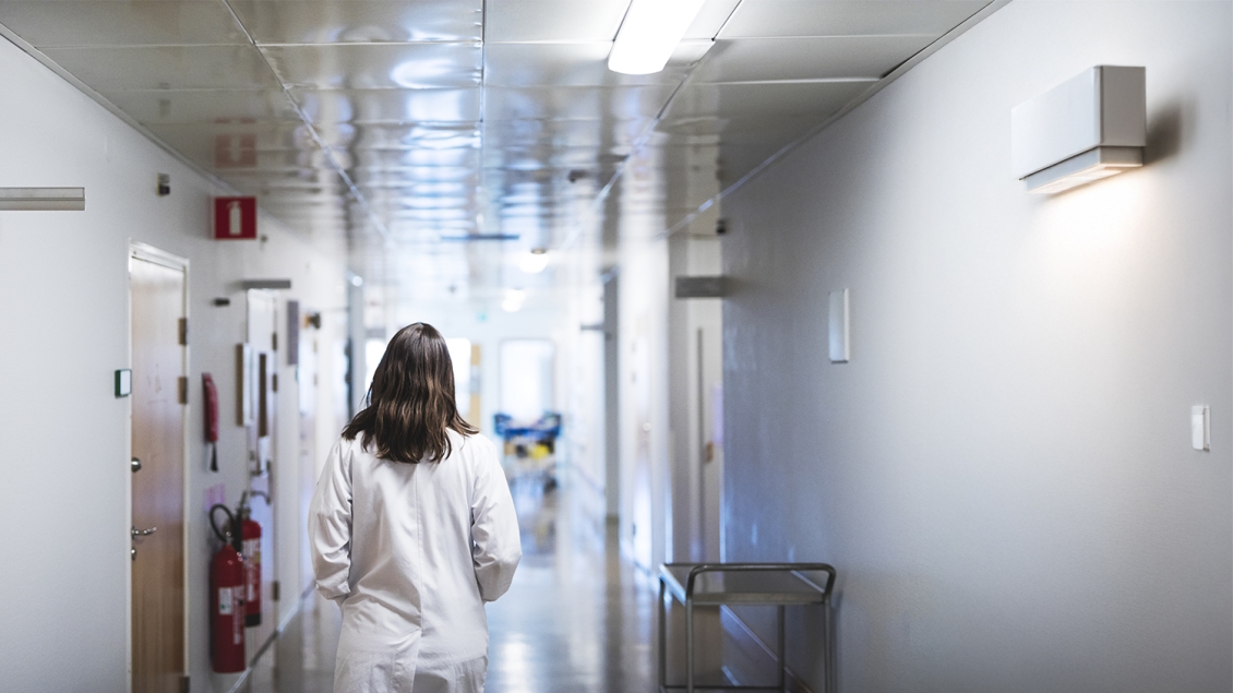 doctor walking down a hospital hallway