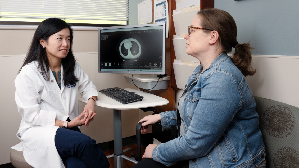 Dr. Qin speaking with patient