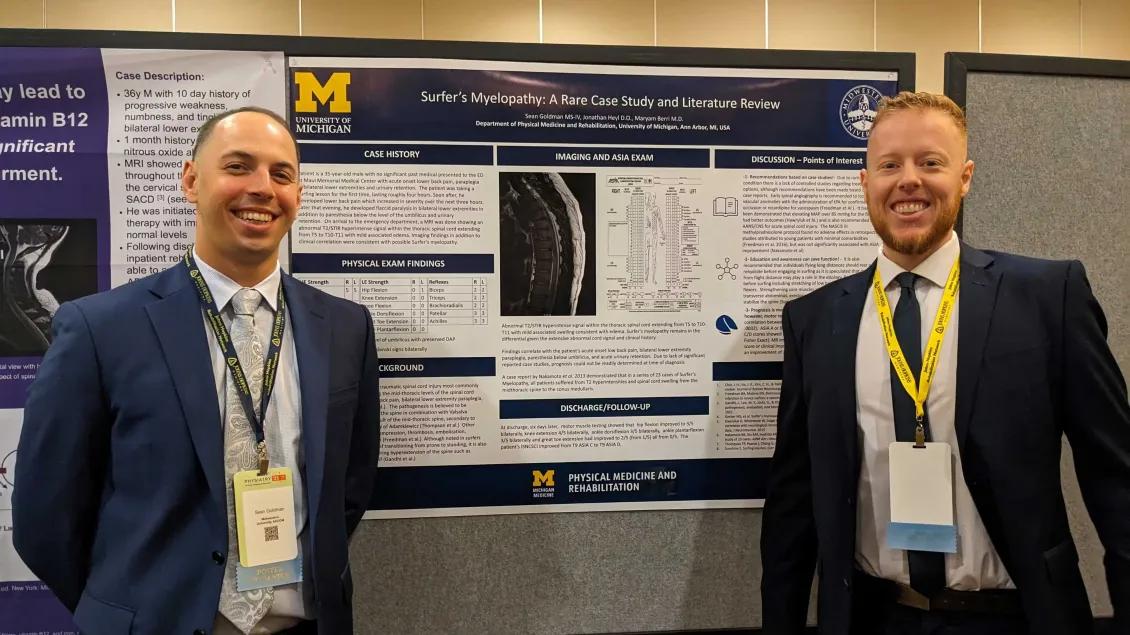 Residents standing in front of a research poster