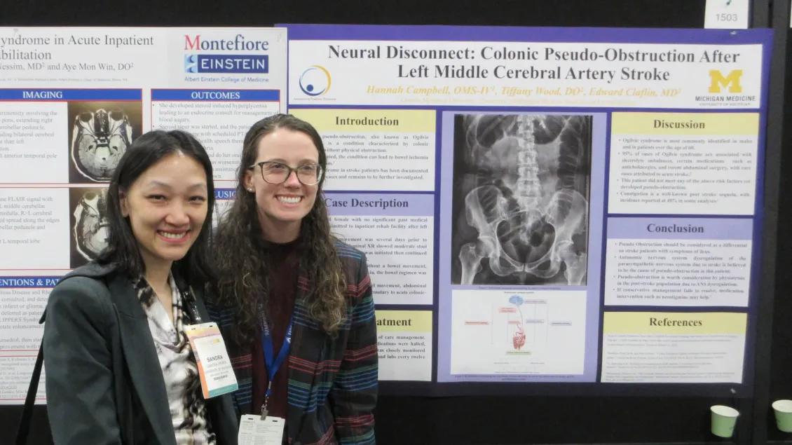 Residents standing in front of a research poster