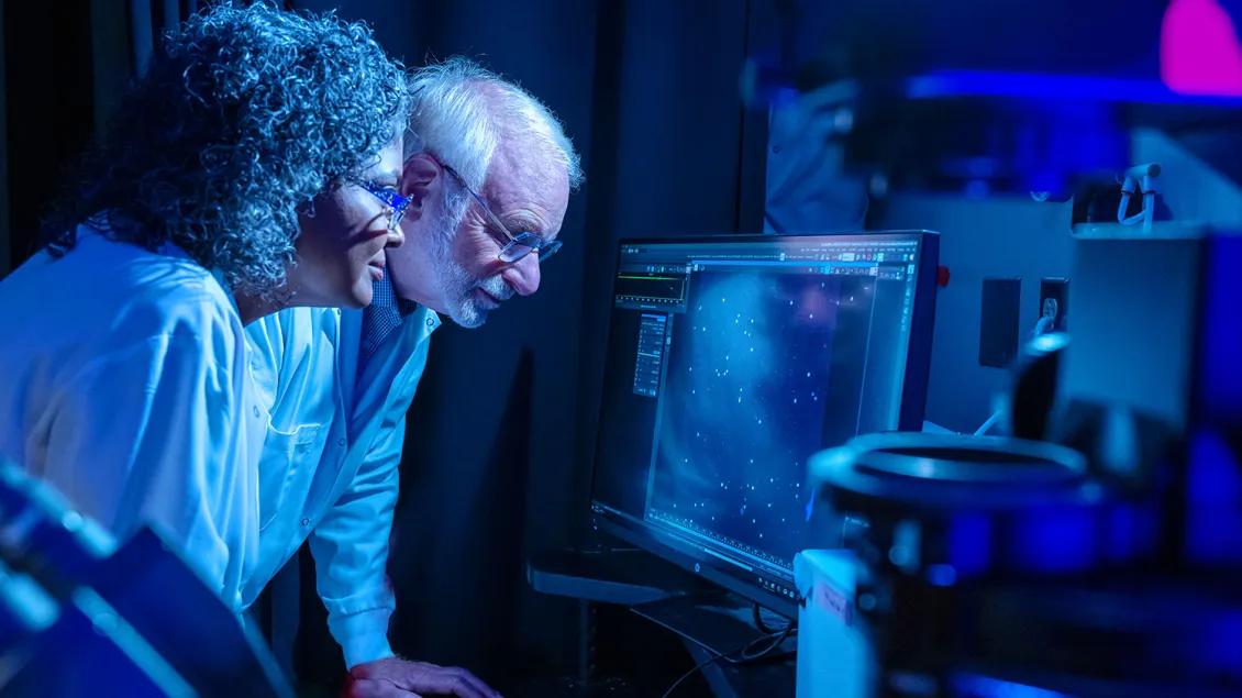 Drs. Max Wicha and Sunitha Nagrath work together in a lab