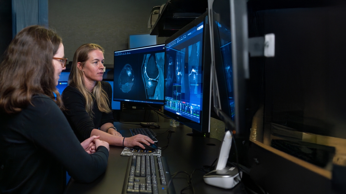 two female radiologists work at a computer