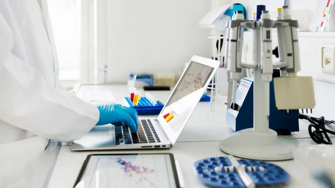 Person using laptop in a lab