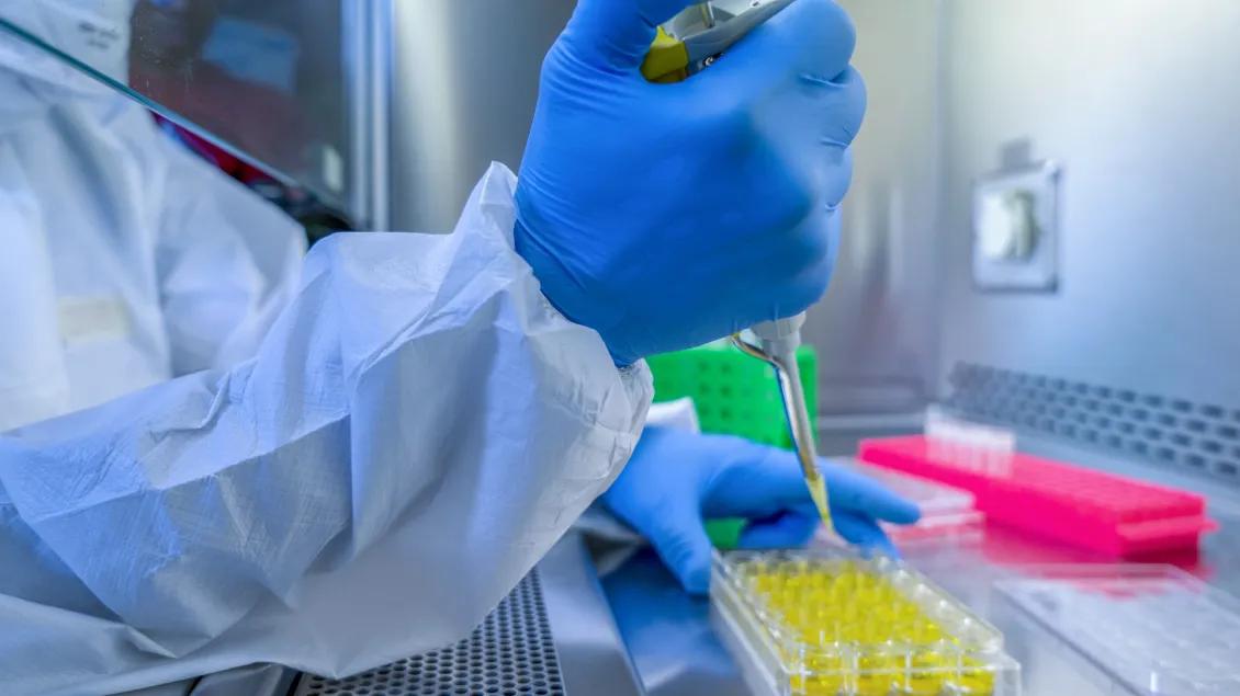 In a Secure High Level Laboratory Scientists in a Coverall Conducting a Research.