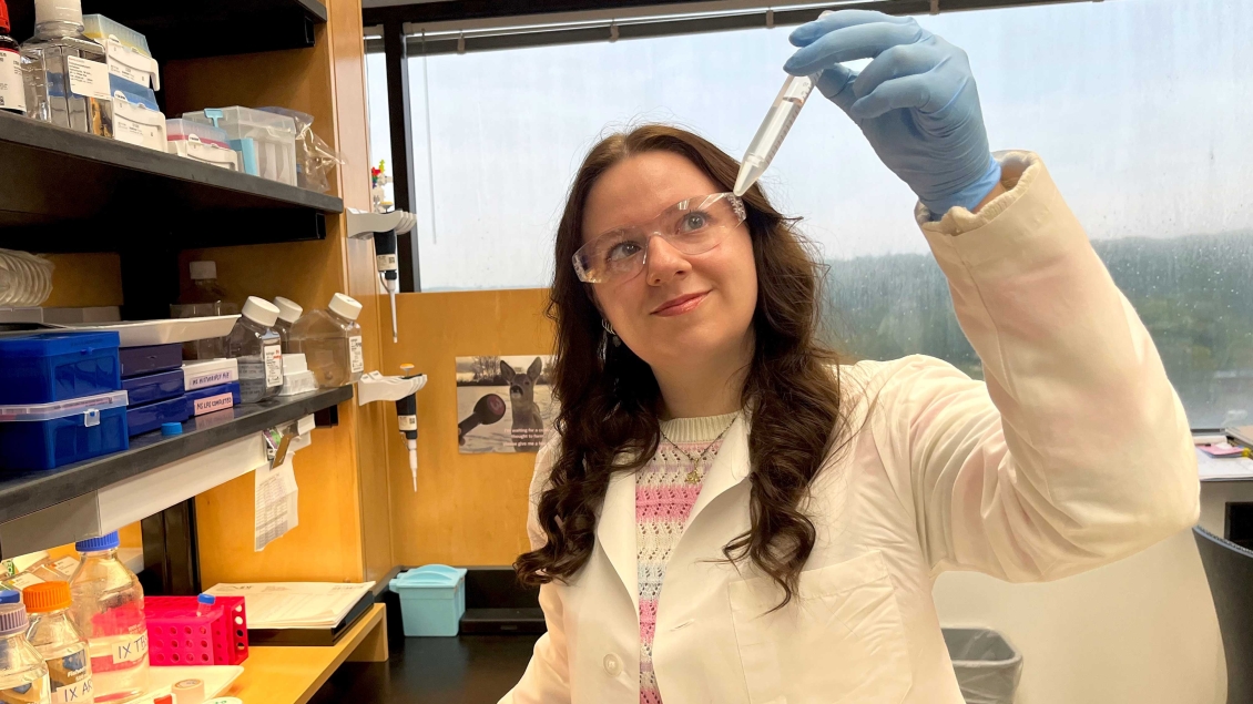 Lab member holding a test tube