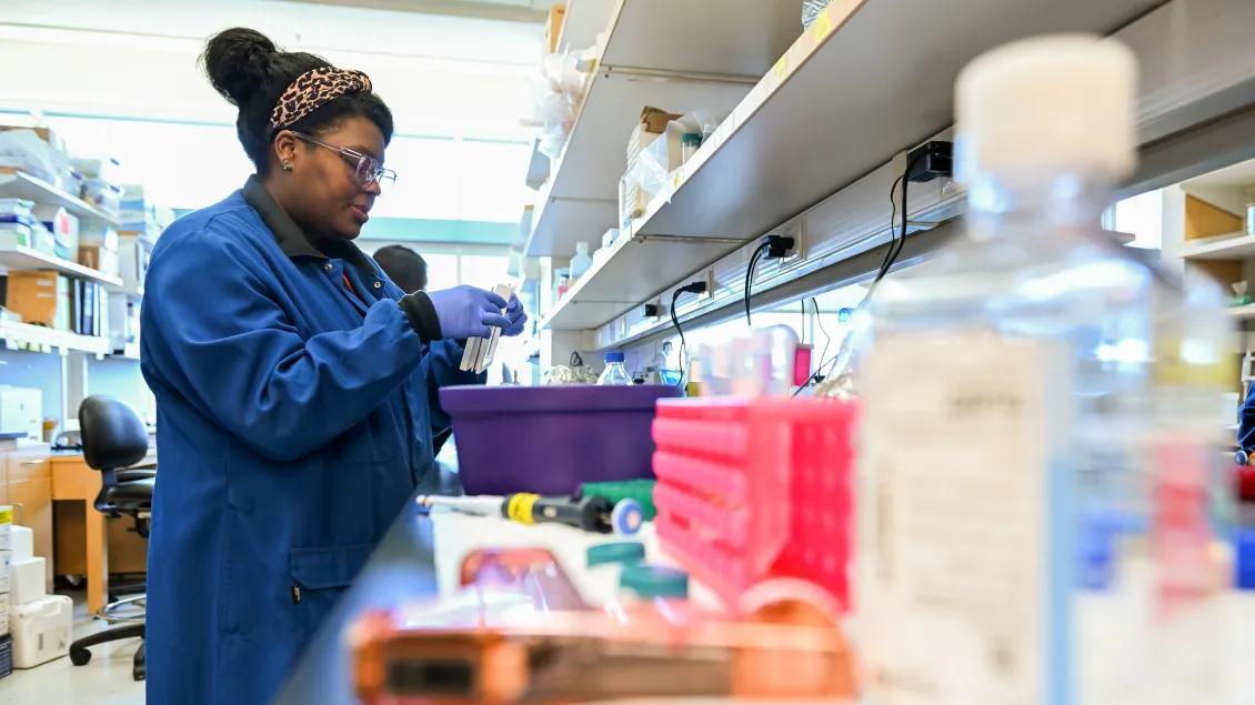 Lab member working with equipment in the lab