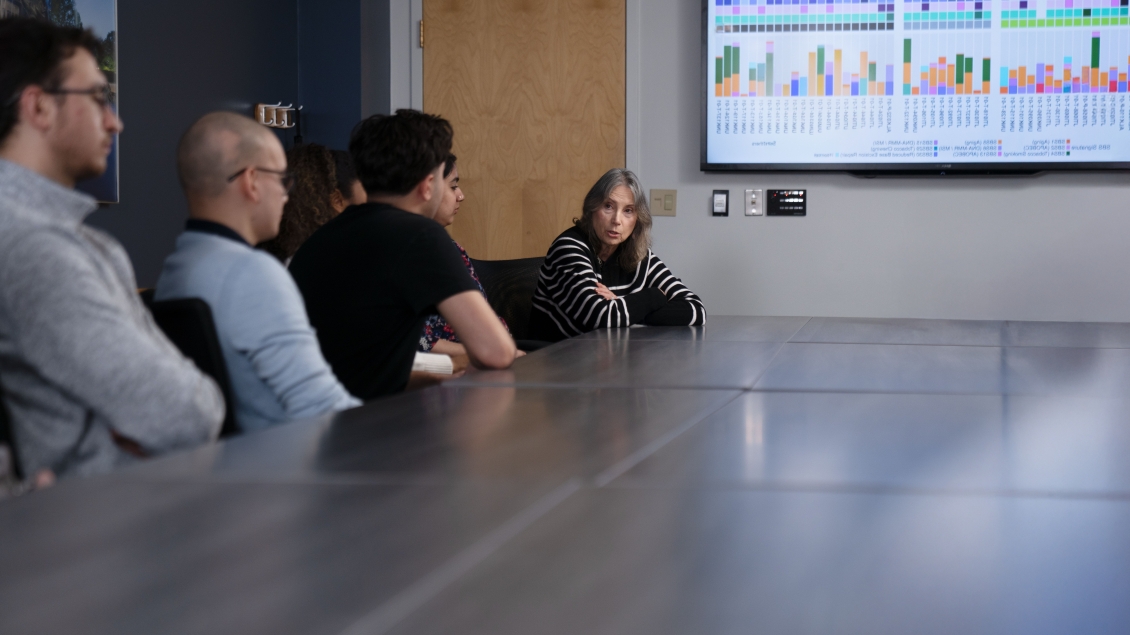 Dr. Merajver leading a meeting while showing data
