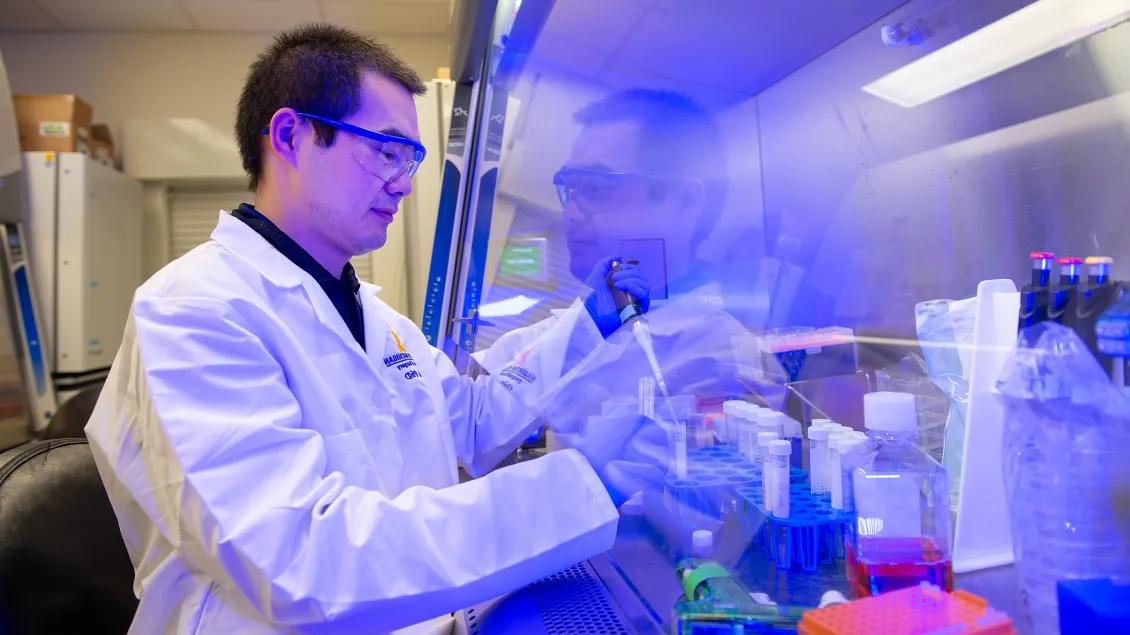 Lab member working with equipment in the lab