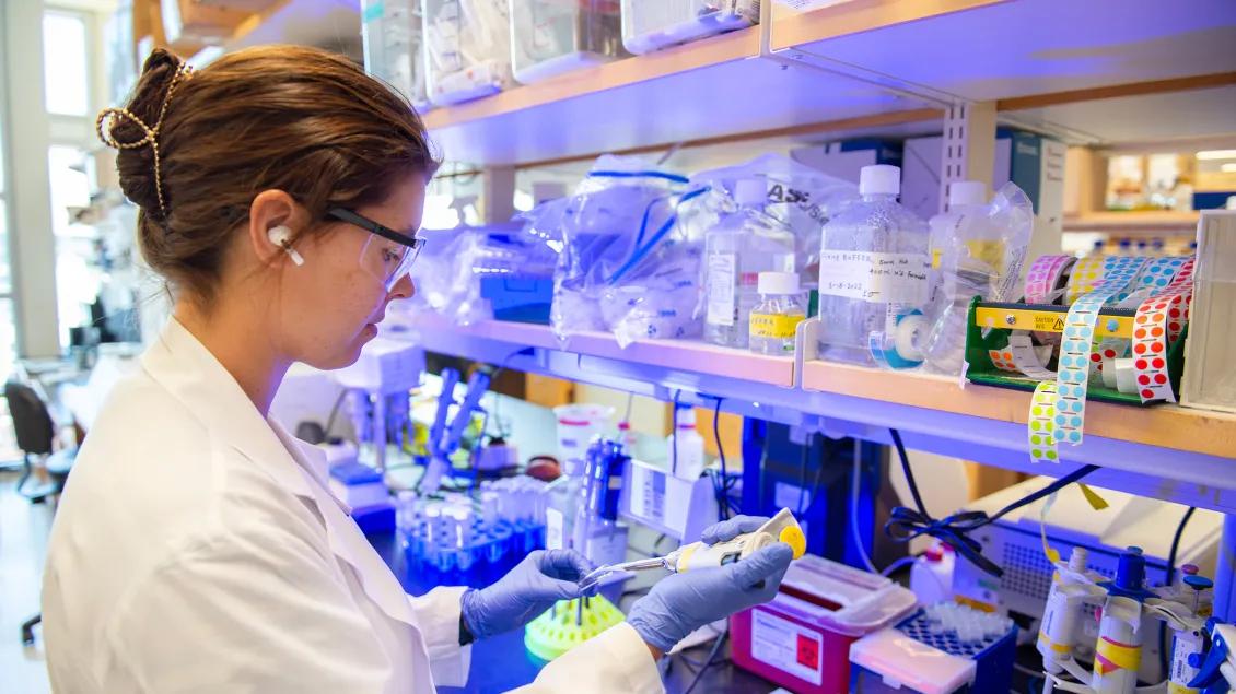 Lab member working with equipment in the lab
