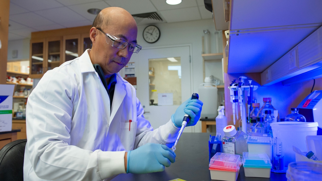 Lab member working with equipment in the lab