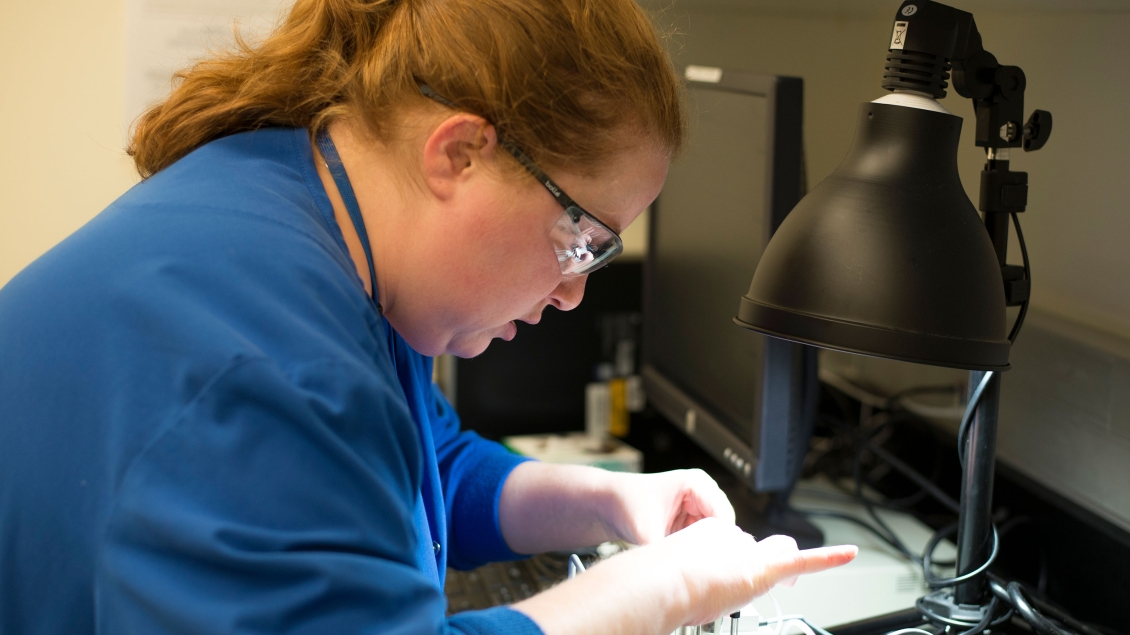 Lab member working with equipment in the lab