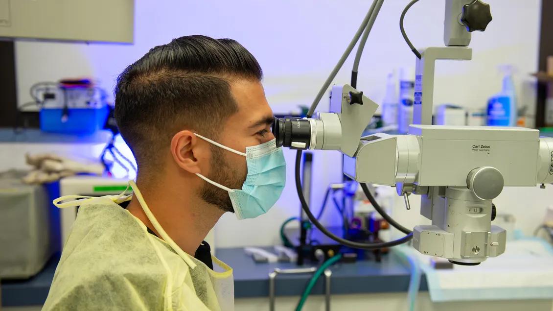 Lab member working with equipment in the lab