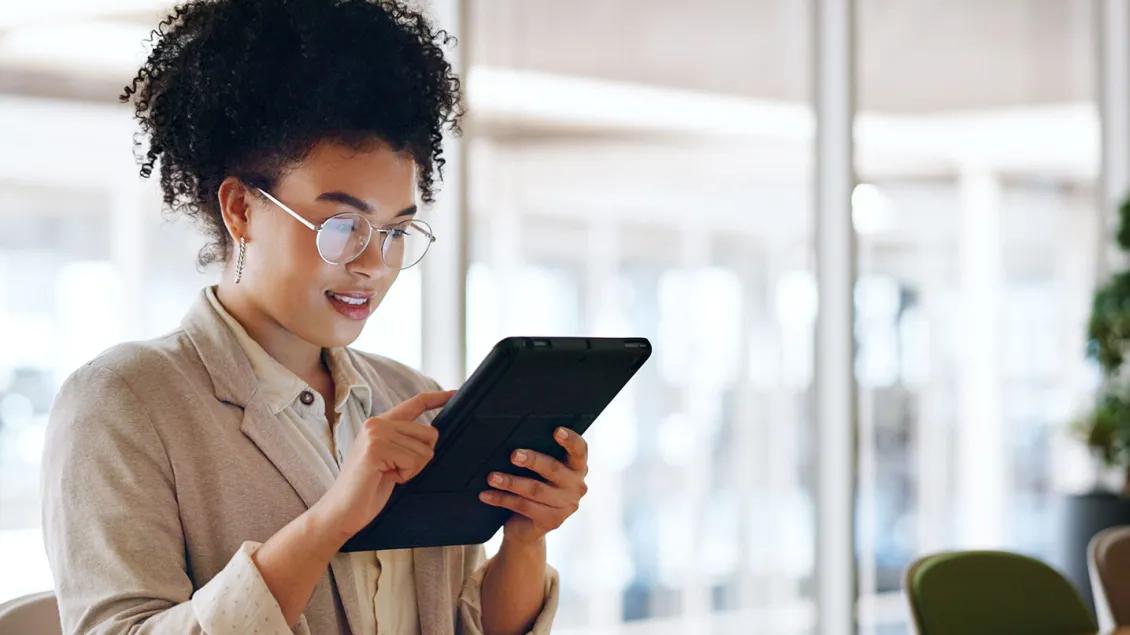 Young Black woman uses tablet to get information