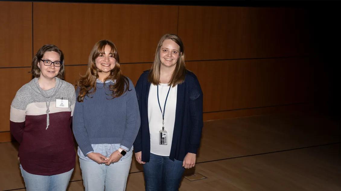 three trainees posing for a photo