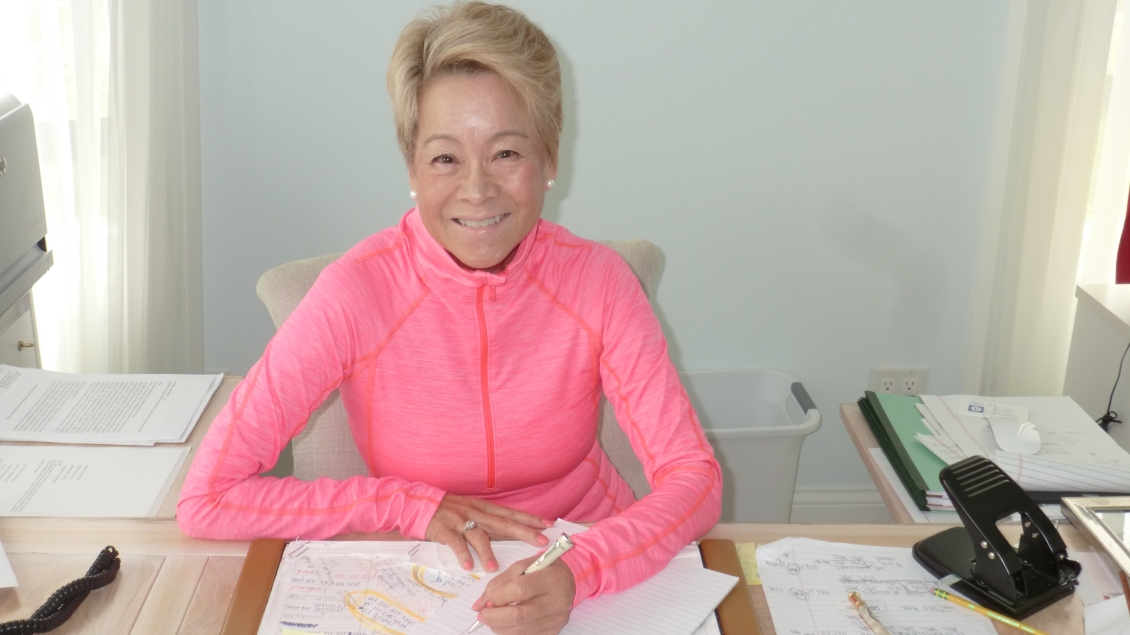 Judith Tam smiling for camera while working from home