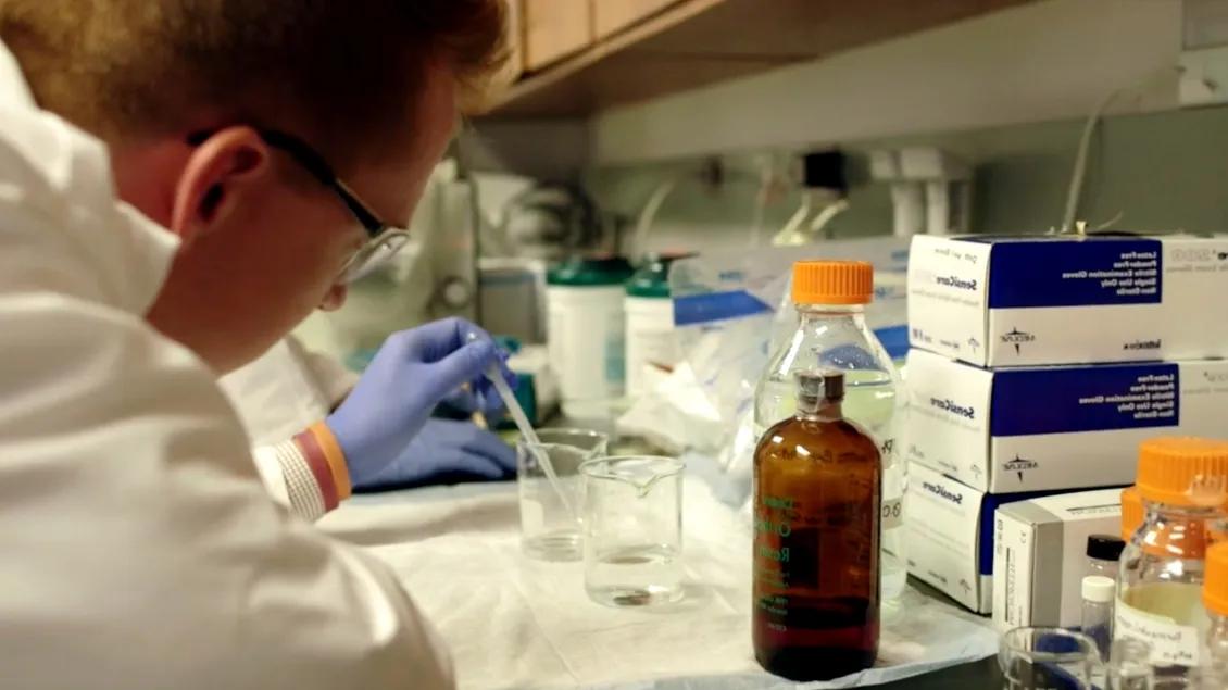 Lab member working with equipment in the lab