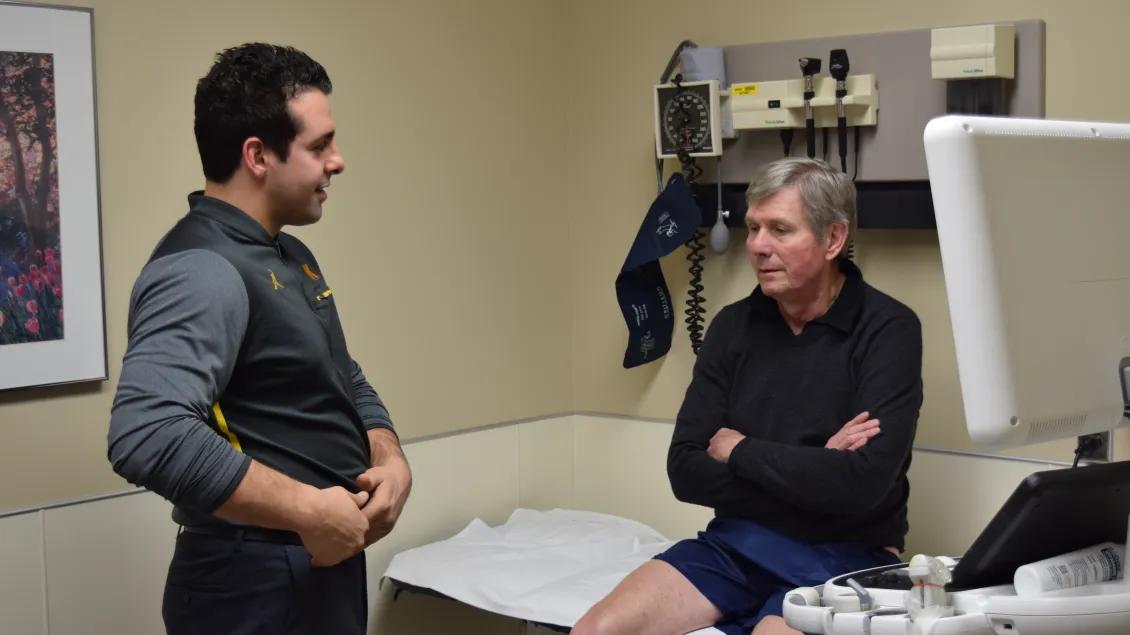 Two people talking in a patient exam room
