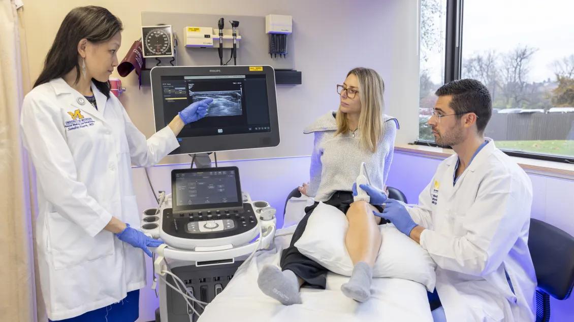 Three people in a patient exam room