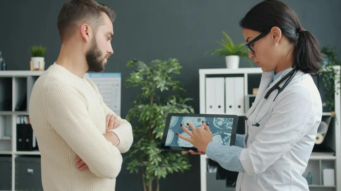 Female provider points to an electronic chart next to a patient