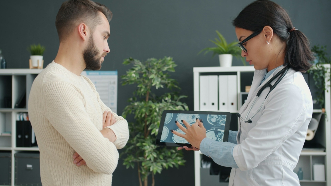 Female provider points to an electronic chart next to a patient