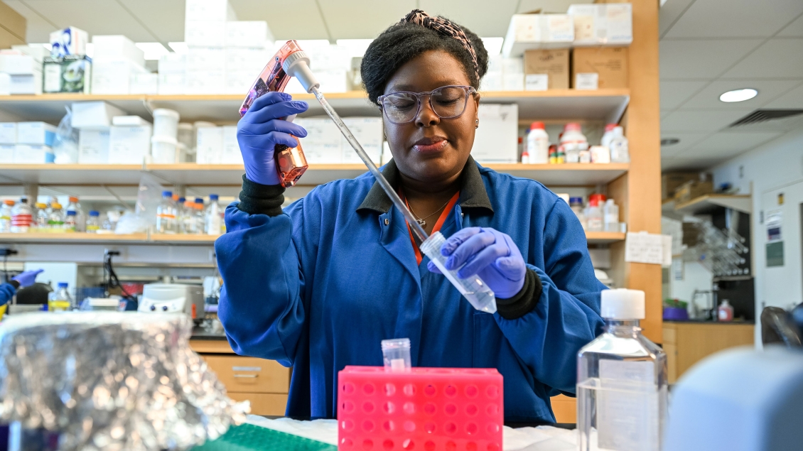 Lab member working with equipment in the lab