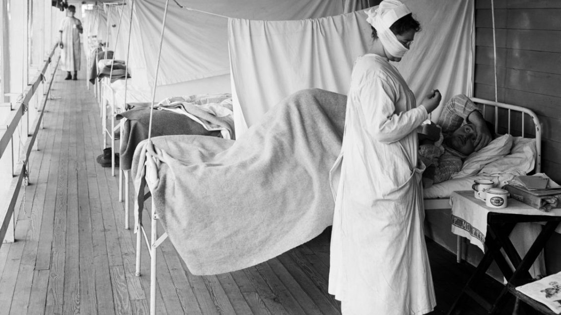 Historical photo of nurse in a hospital ward during a pandemic