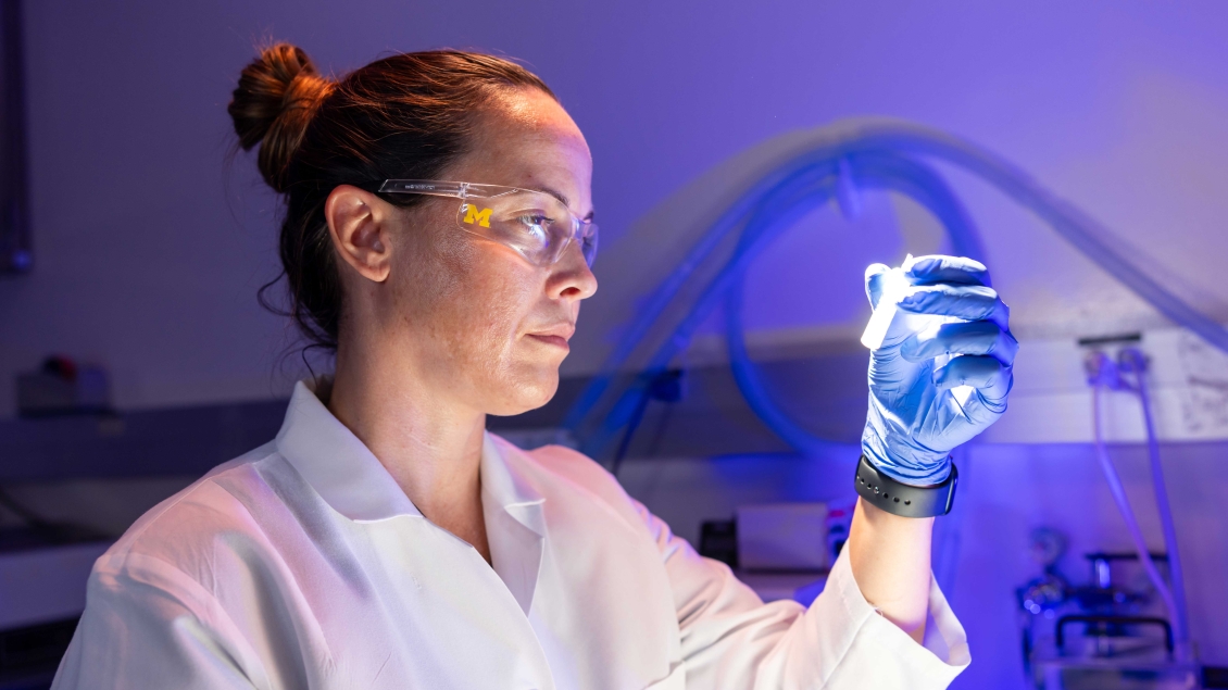Lab member holding a test tube