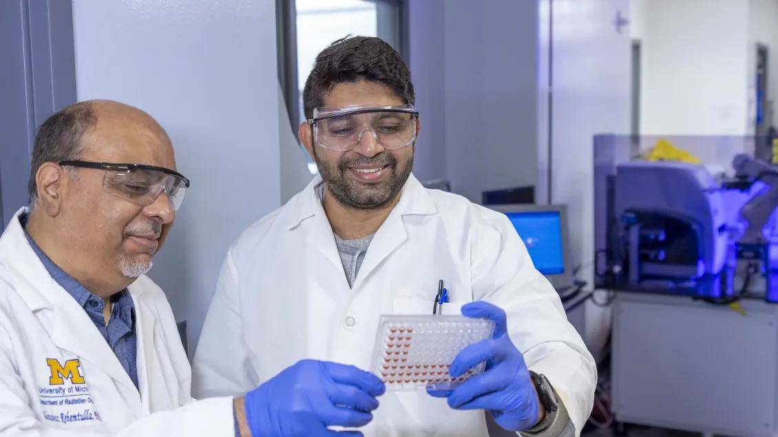 Alnawaz Rehemtulla with a team member holding a sample