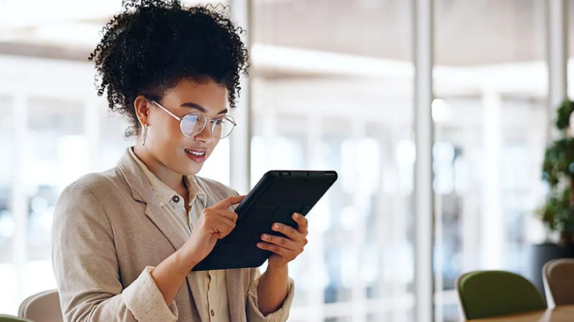 Black woman reads from her tablet