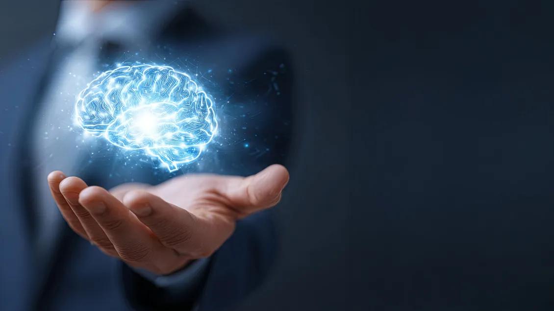 Hand holds image of brain