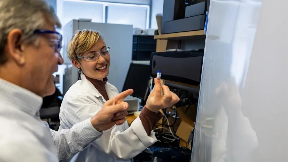 two researchers looking at an item