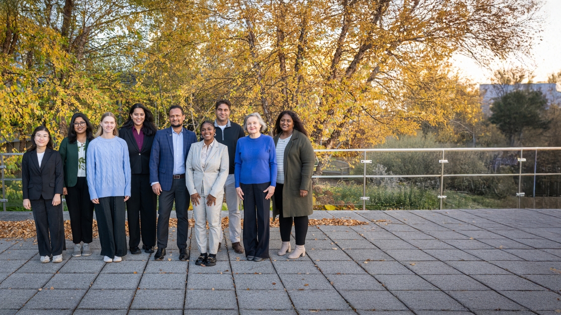 group of people posing for a photo outside