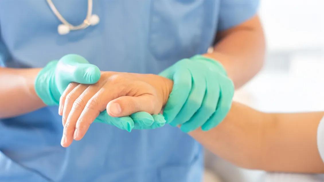 patient and doctor holding hands