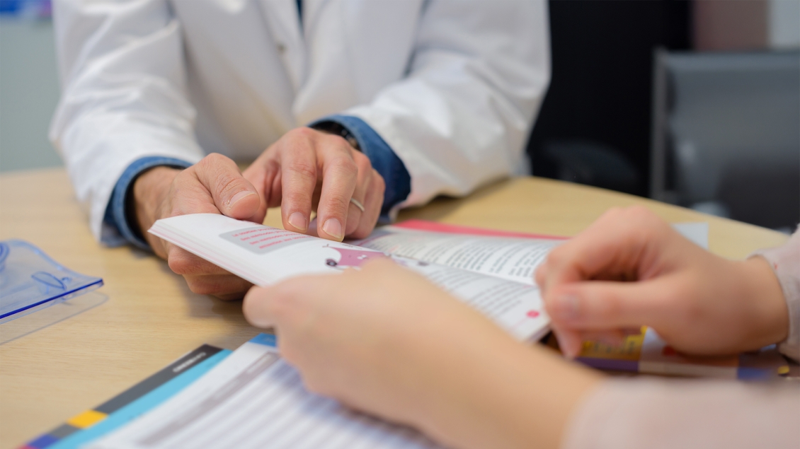 close-up of doctor looking at a publication