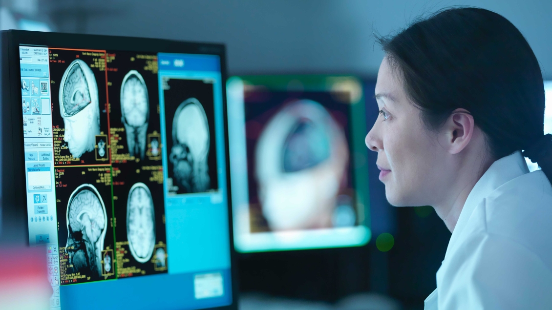 Doctor looking at brain scans on computer