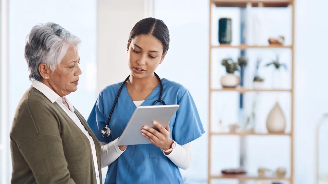 patient and nurse talking using ipad