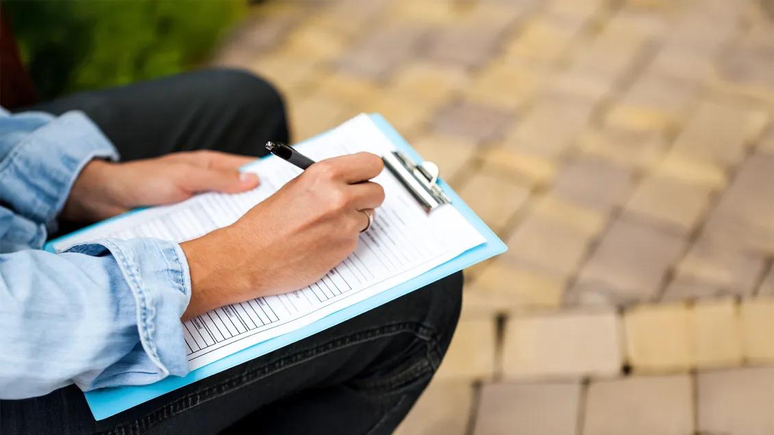woman writing on a paper form