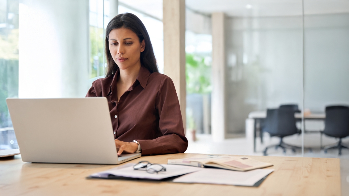 woman working on a laptop in an office