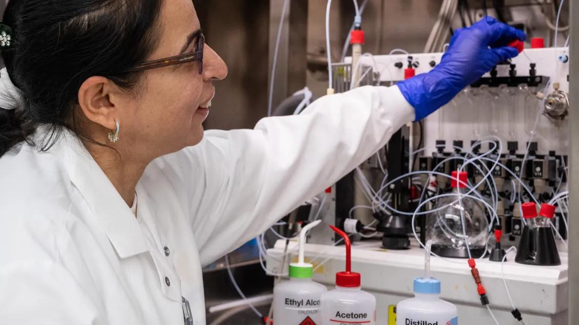 A chemist works on an automated radiochemistry module.