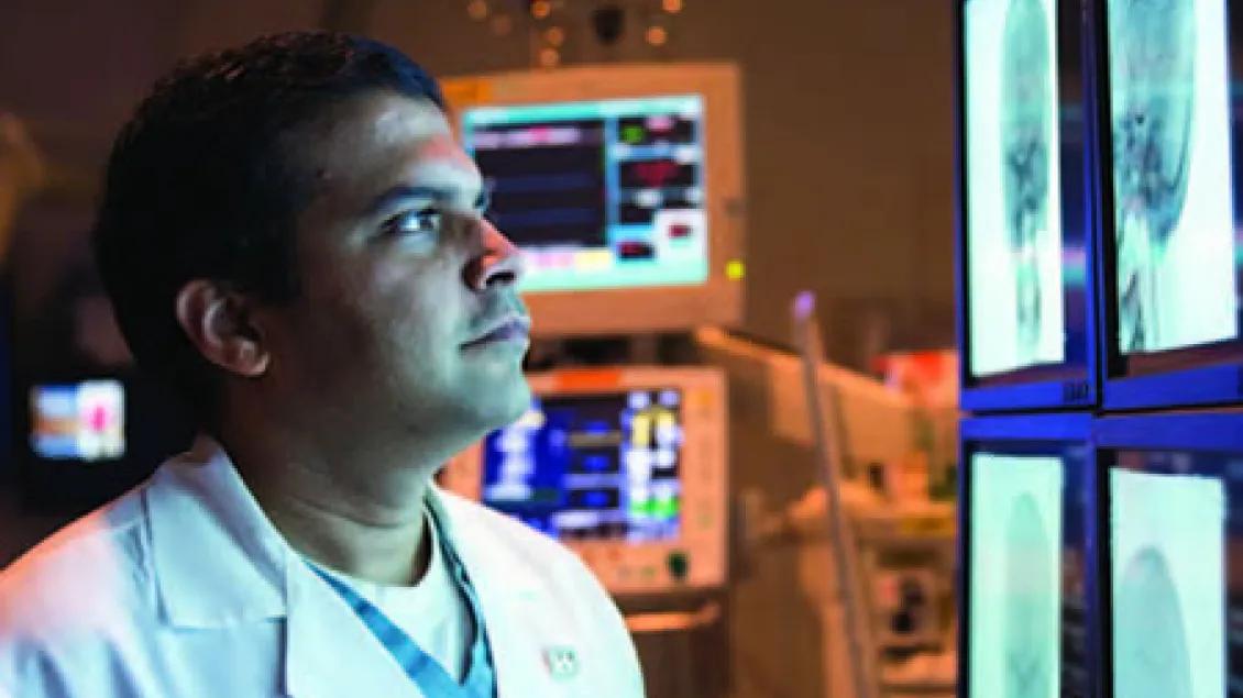 Dr. Chaudhary looking at screen with images