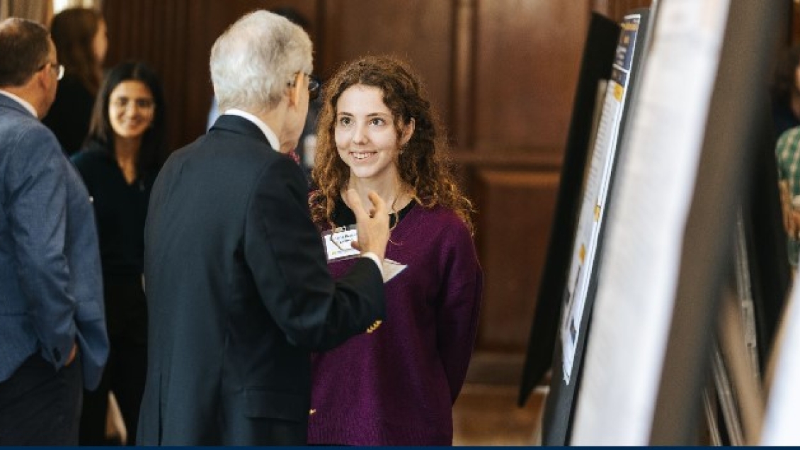 A woman smiles while speaking with another attendee at the CRN Annual Symposium.