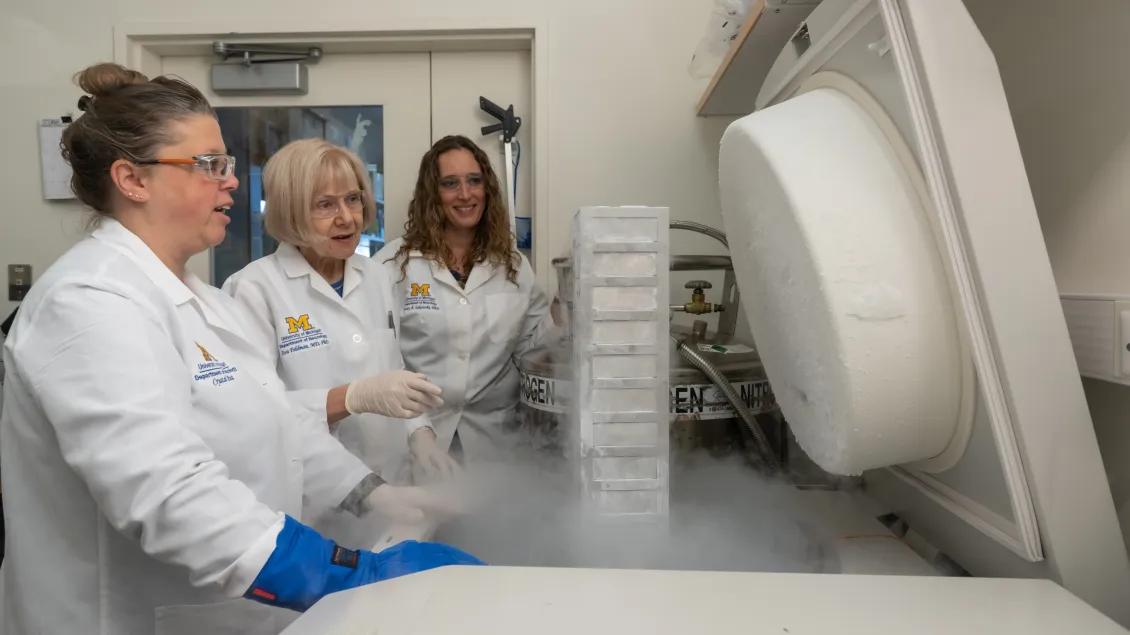 Crystal Pacut with Drs. Eva Feldman and Stacey Jacoby looking at samples in the lab