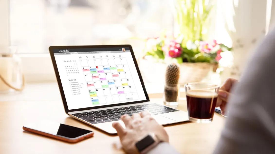Person viewing calendar on laptop