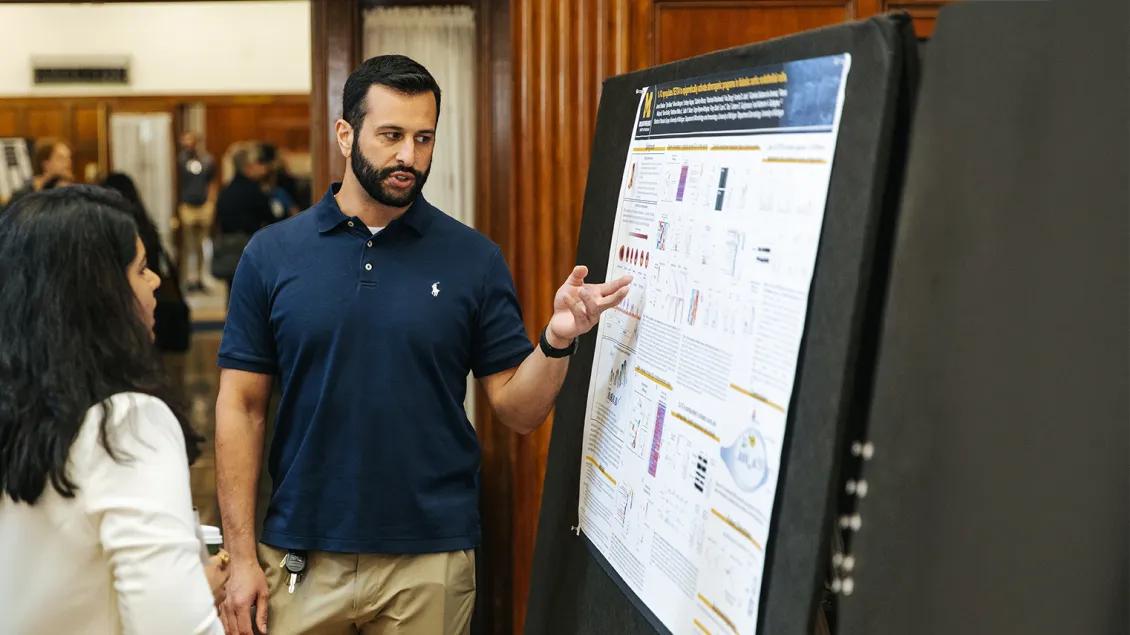 people talking at a poster presentation