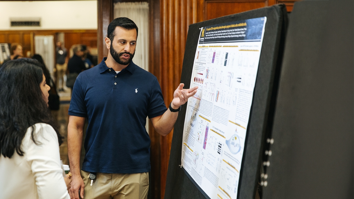 people talking at a poster presentation