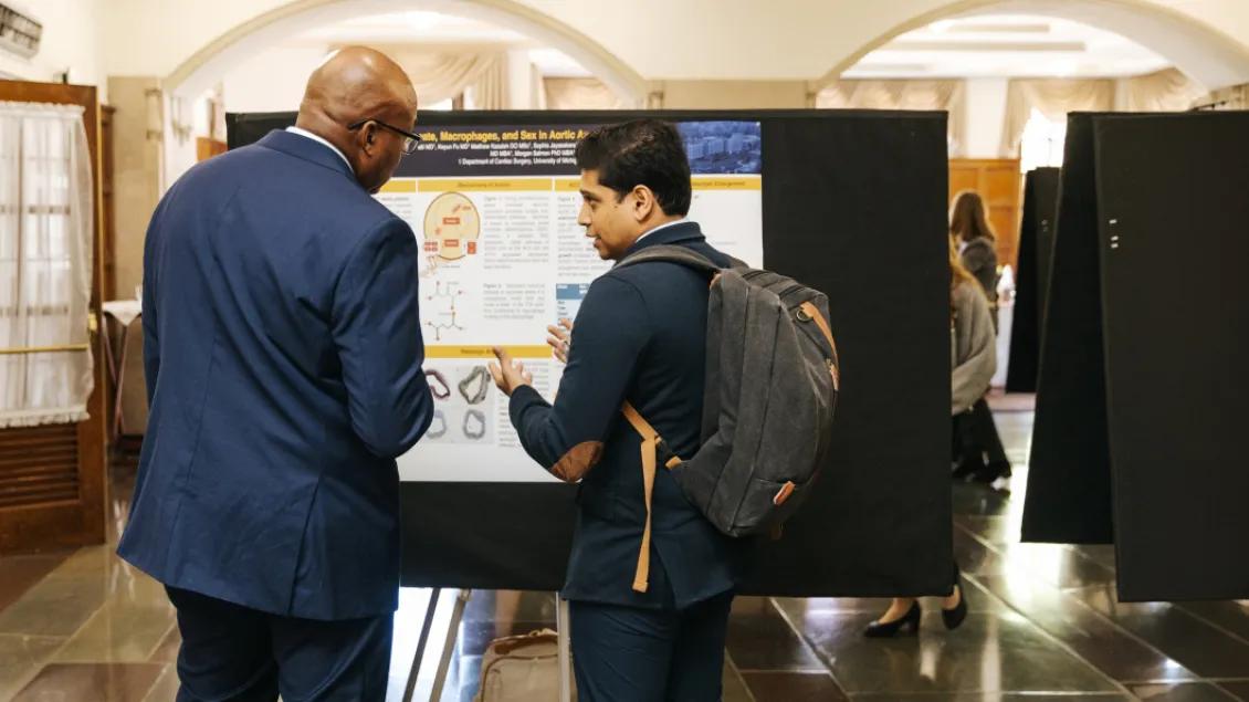 people talking at a poster presentation